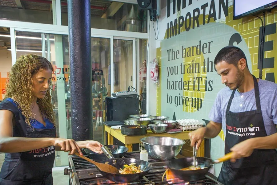 Participants cooking at the stove