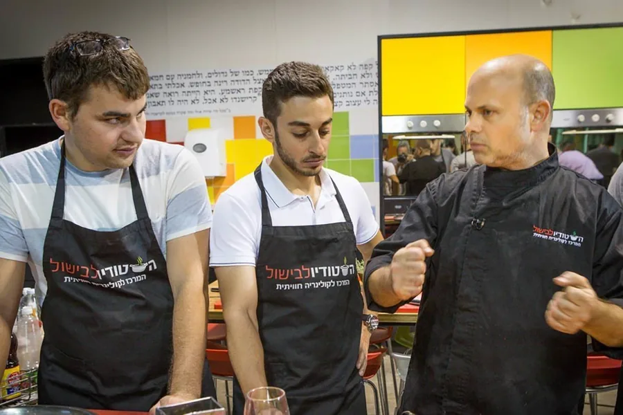 Three participants and a chef at one workstation